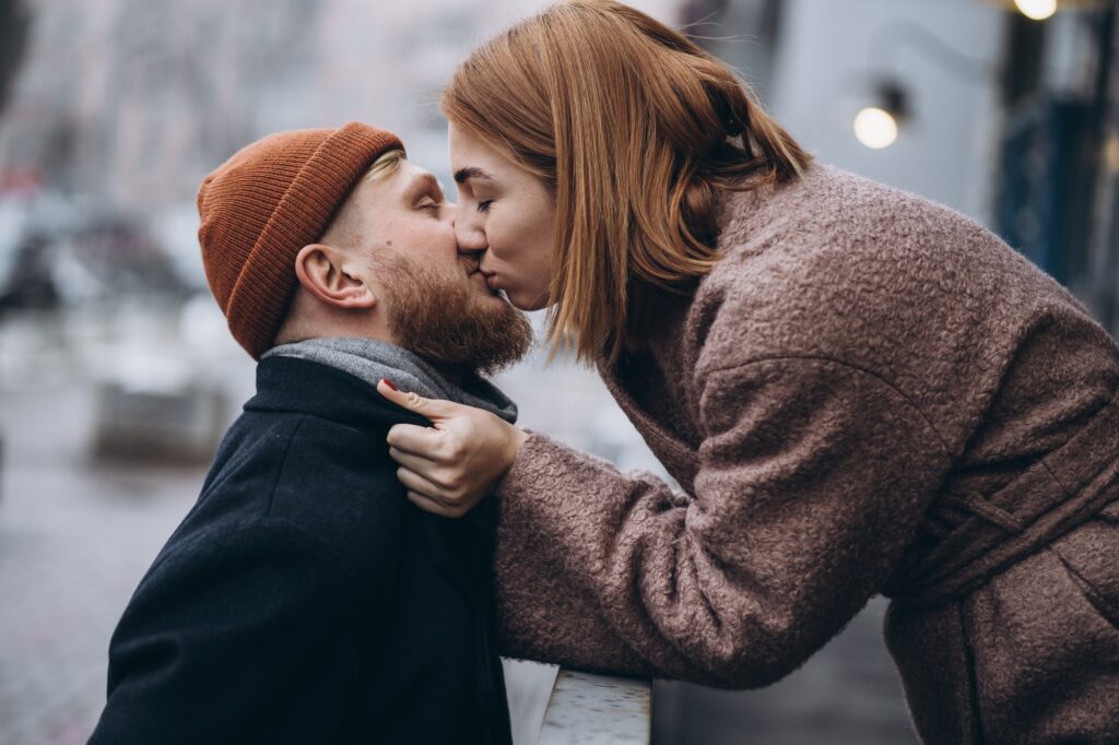 Adult loving couple kissing on a street