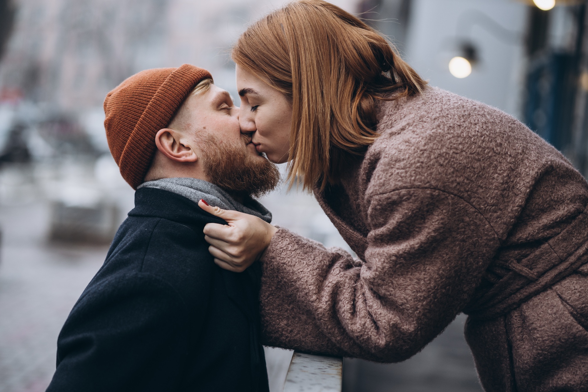 Adult loving couple kissing on a street
