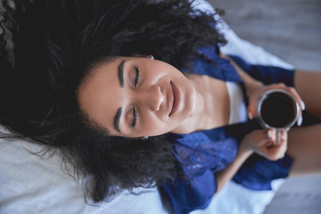 Relaxed young woman enjoying silence at home