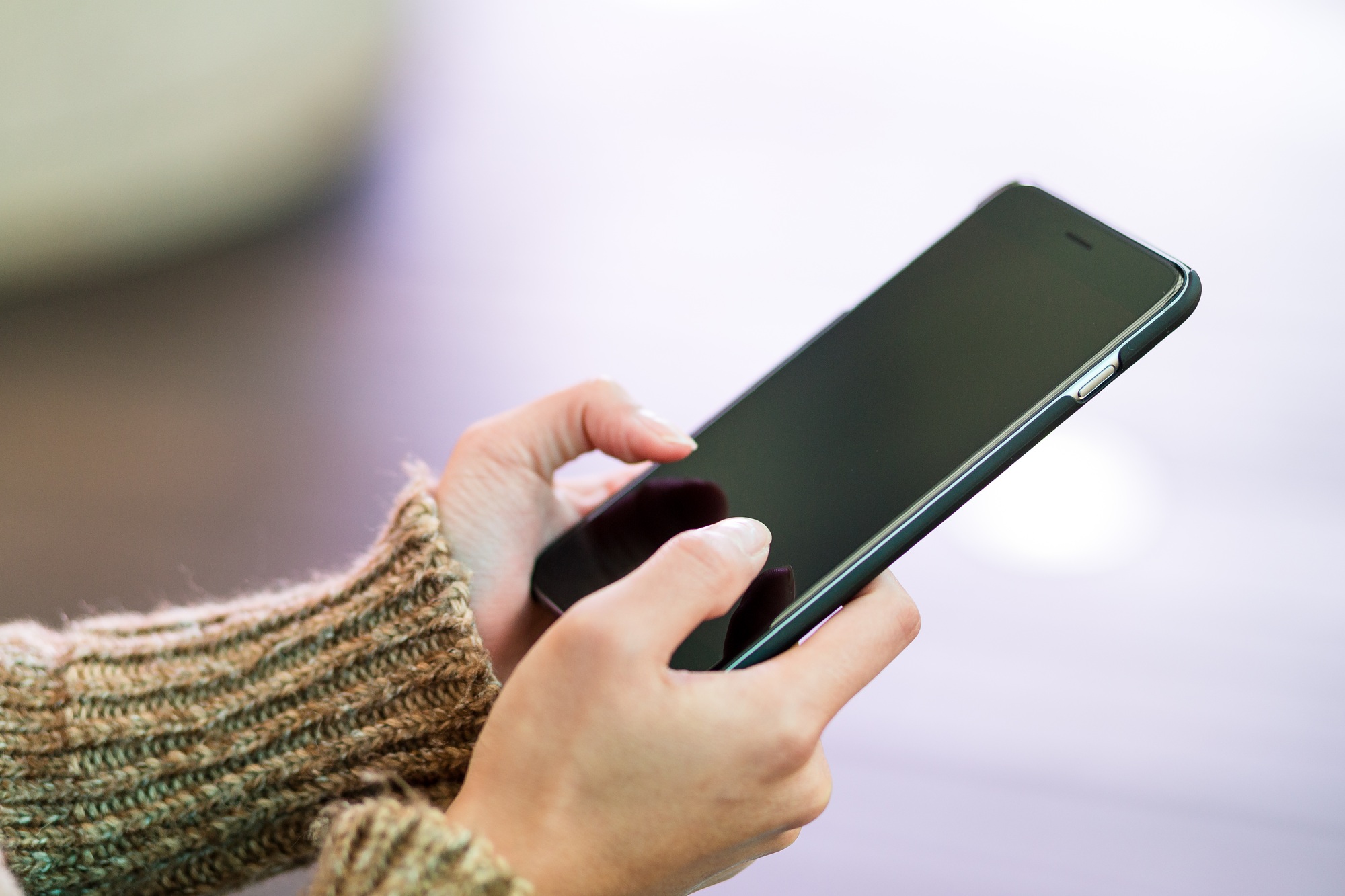 Woman sending text message on cellphone